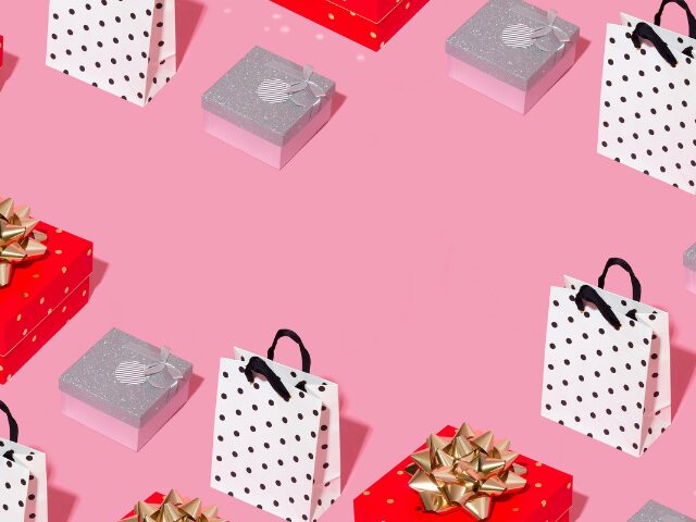 ドット柄のバッグやシルバーと赤のプレゼントボックスが並んでいるピンクの床